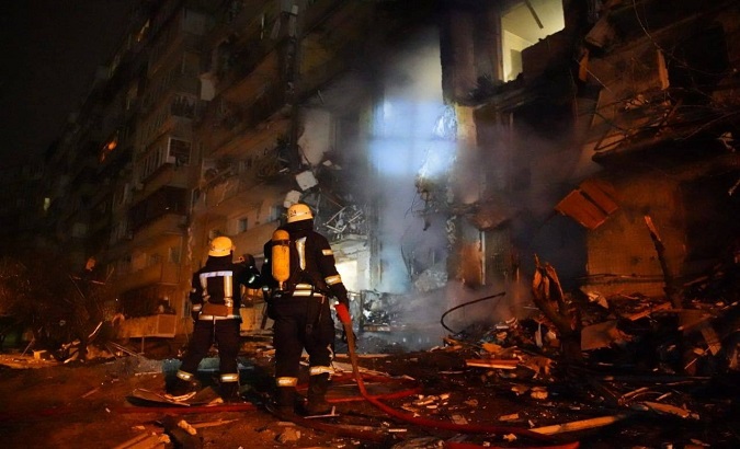 Firefighters extinguish the fire at a residential building hit by a bomb, Kyiv, Ukraine, Feb. 25, 2022.