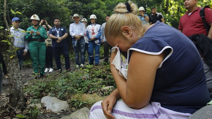 Familiares de los mineros desaparecidos permanecen fuera del socavón a la espera de noticias sobre su rescate.